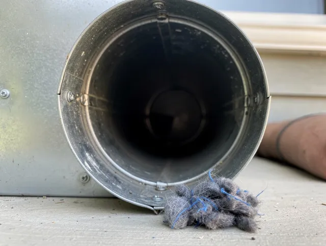Swampscott Dryer Vent Cleaning technician using specialized equipment to clear severe dryer vent blockage in Swampscott